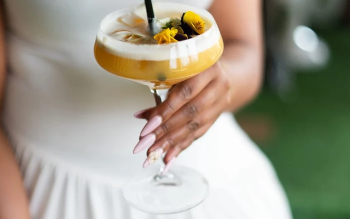 A guest holding a signature cocktail