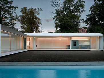 Large-format minimal-frame sliding doors in a tall architectural opening