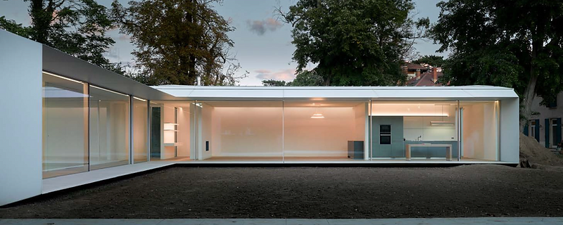 Large-format minimal-frame sliding doors in a tall architectural opening