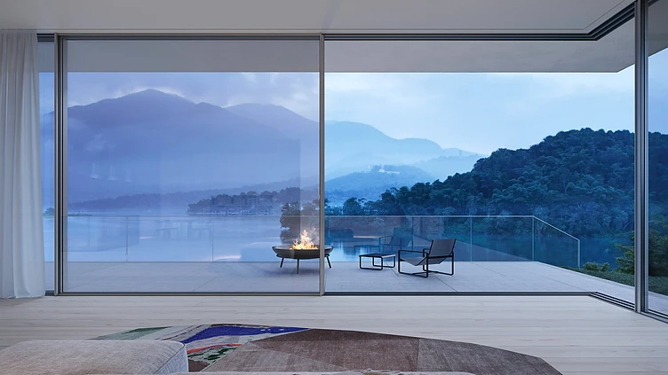 Minimal-frame sliding glass doors opening a living space onto a terrace