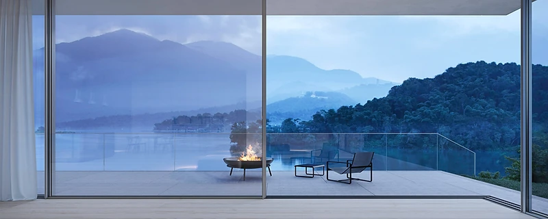 Minimal-frame sliding doors opening a living space onto a garden