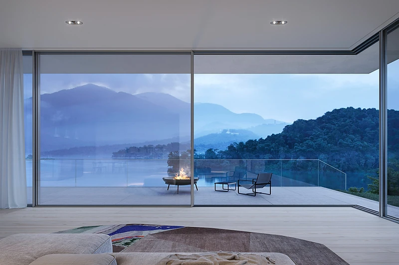 Solarlux cero minimal-frame sliding doors in a garden room at dusk