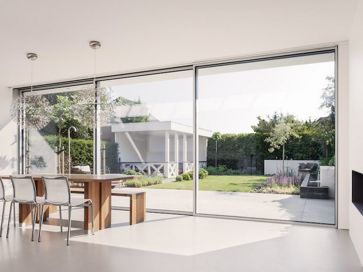 Minimal-frame sliding door installation with large glass panels and a slim central interlock seen from inside