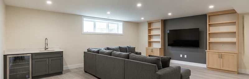 A finished basement living room in a Liberty, MO home with warm lighting and modern furnishings.