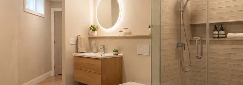 A newly installed basement bathroom with modern fixtures and waterproof wall finishes