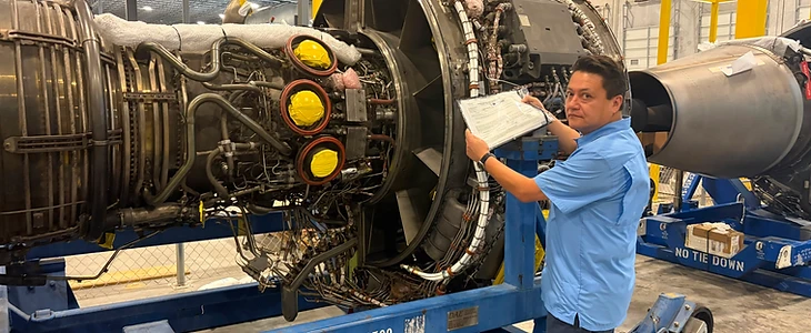 Technician inspecting jet engine