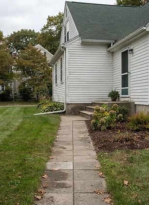 Waltham landscaping with lawn, planting beds and a paver walkway