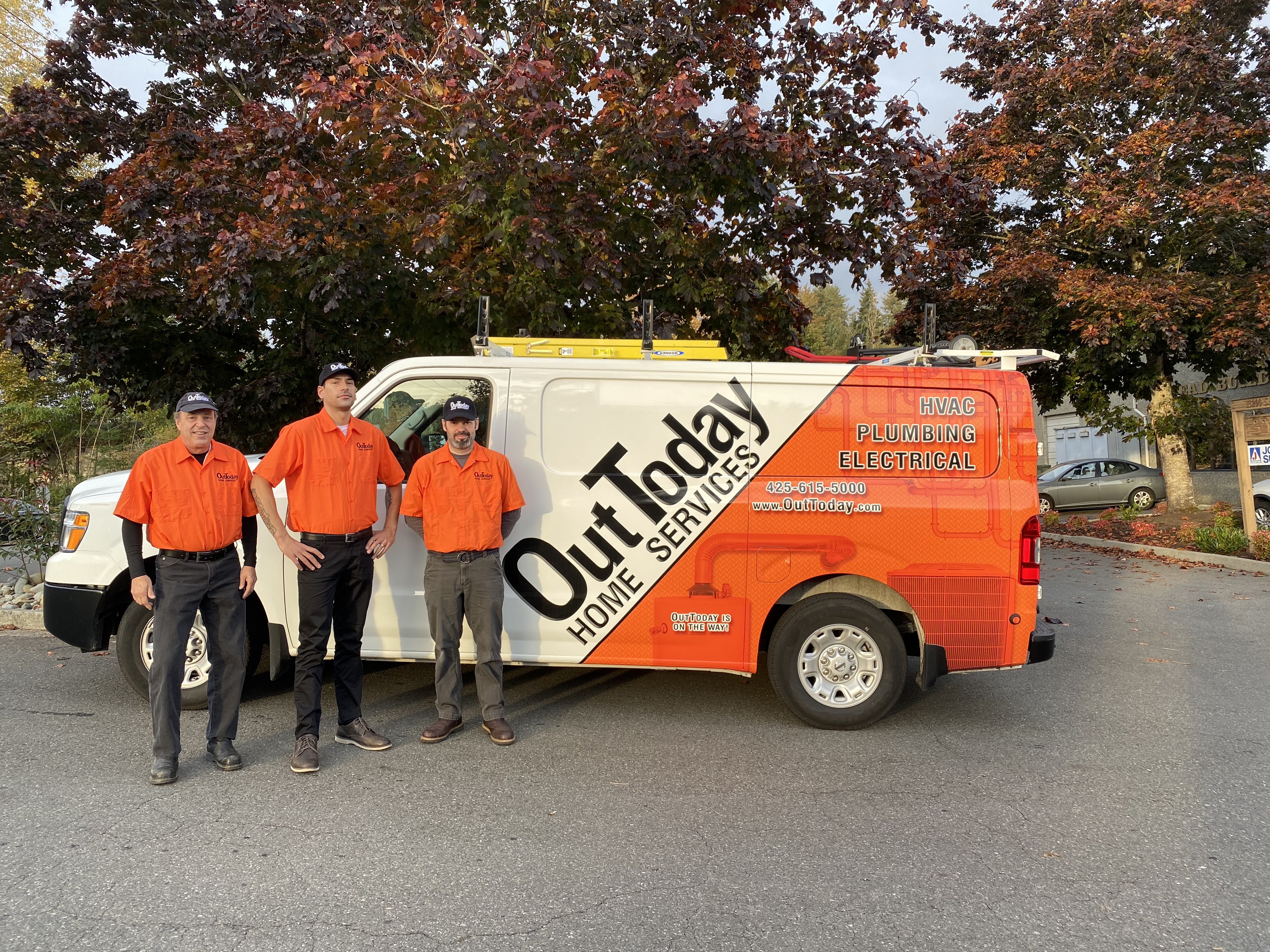 OutToday crew standing in front of a branded service van
