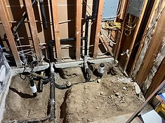 Rough-in plumbing and electrical run through open studs and excavated slab