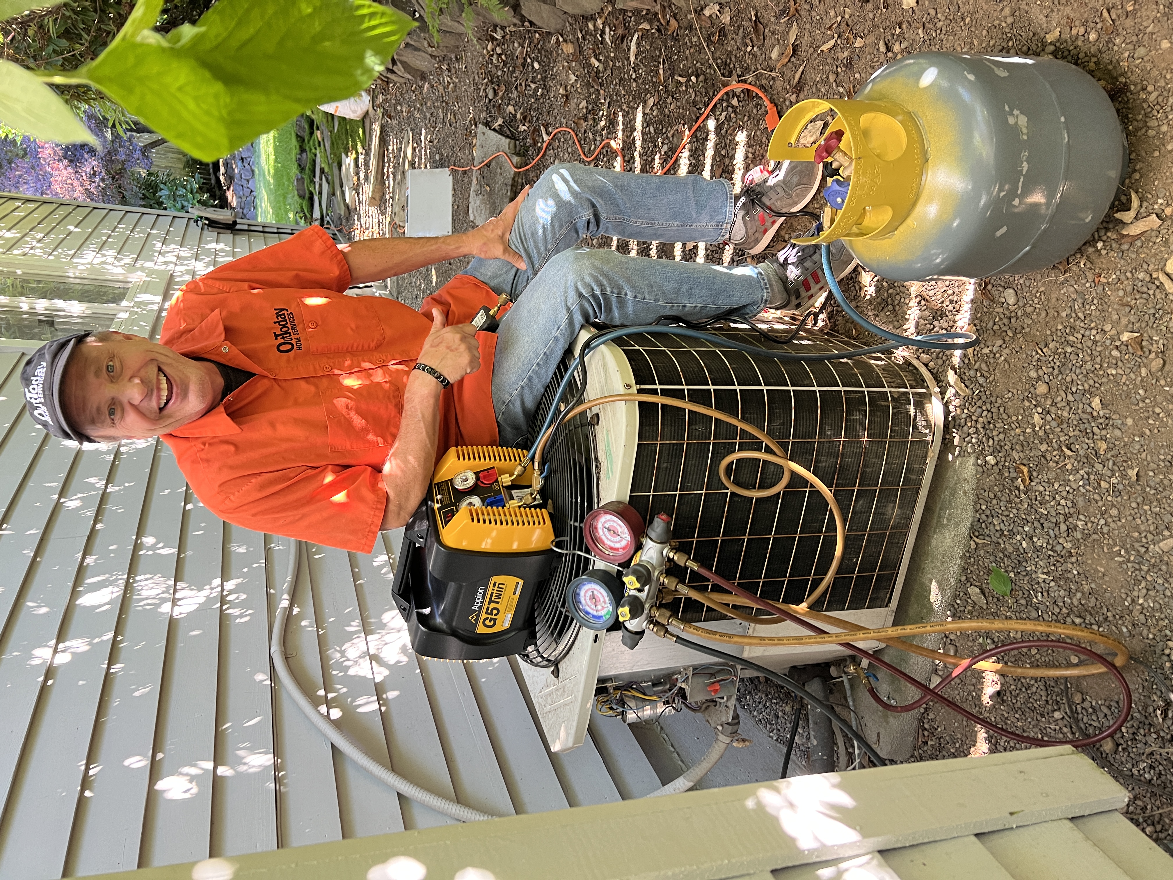 OutToday HVAC technician servicing an outdoor condenser unit