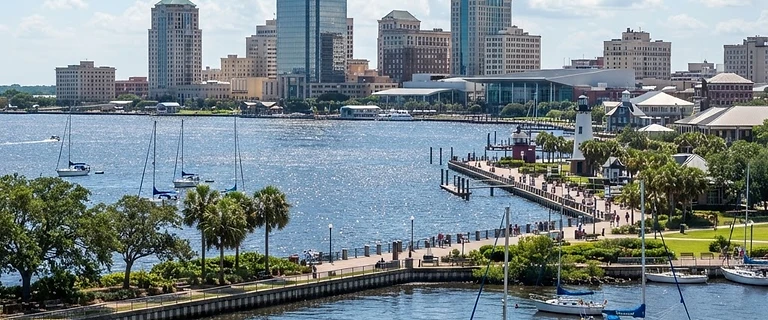 Mobile, Alabama waterfront with the downtown skyline and palm trees along the bay