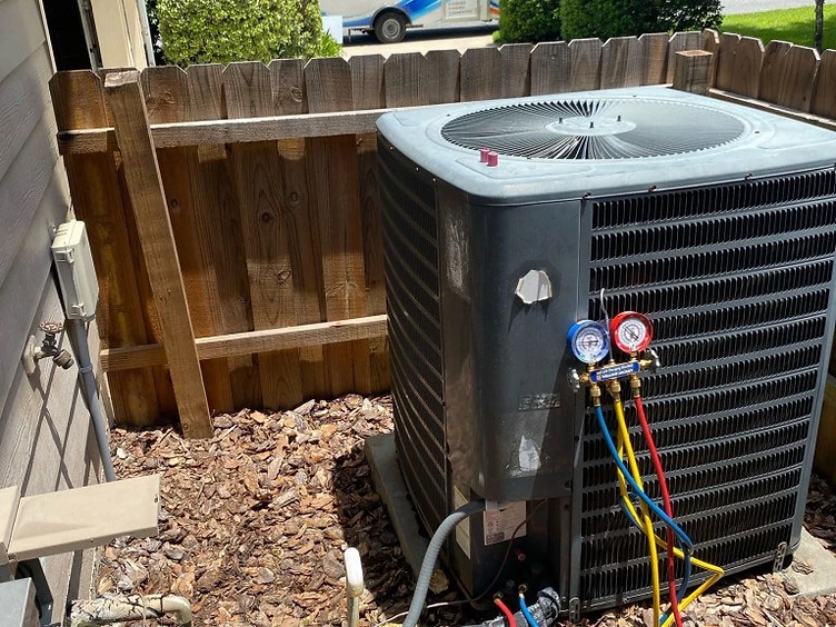 Florida Home Performance technician servicing a residential HVAC condenser unit