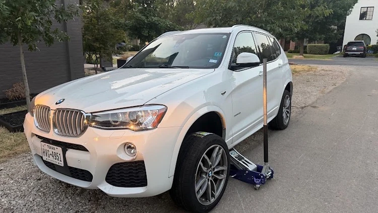 Passenger tire replacement — BMW X3 on the roadside