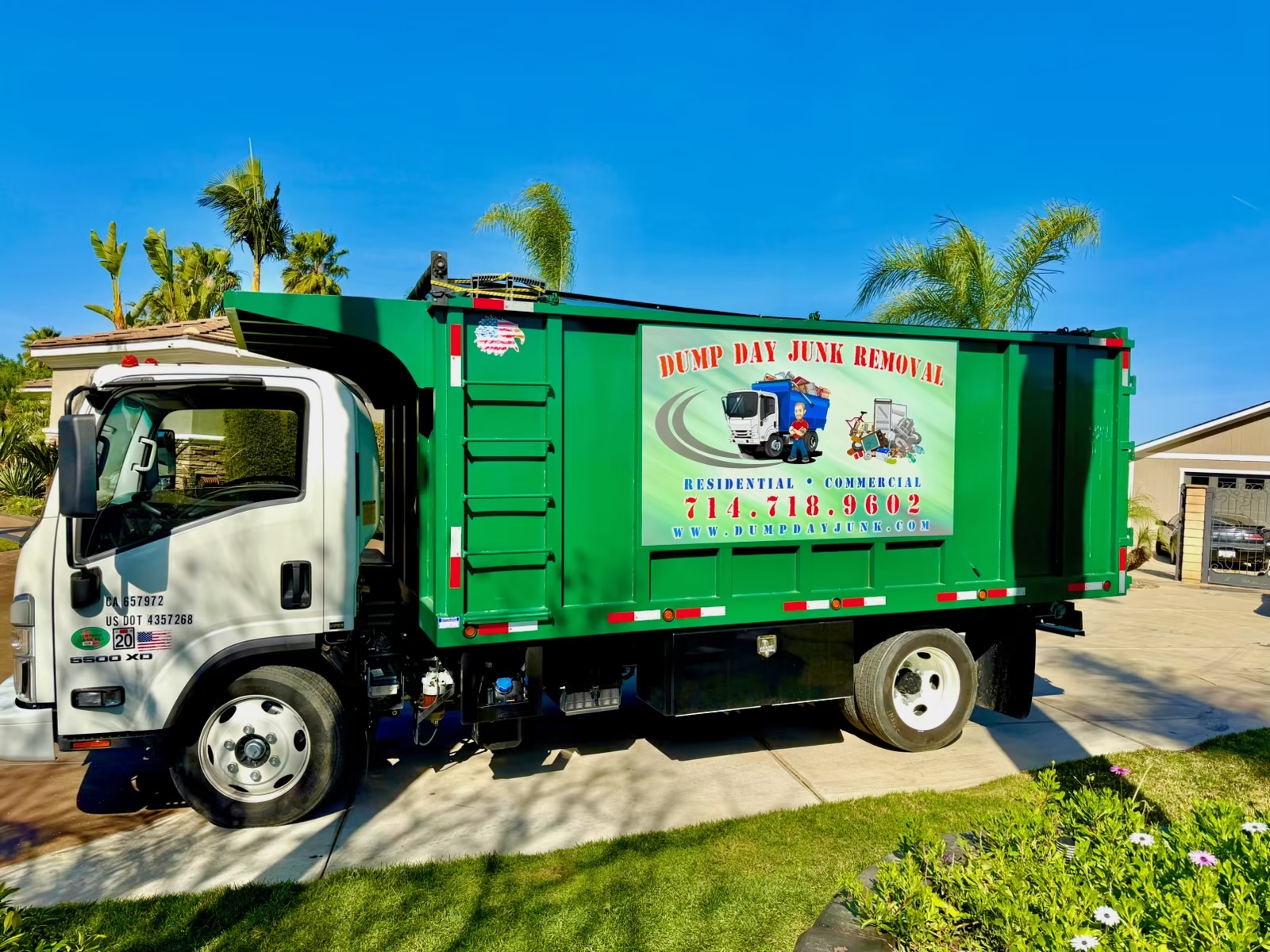Dump Day junk removal truck on a Corona driveway