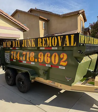 Dump Day 12-yard dump trailer side view on a Corona driveway