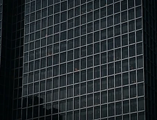 Precise glass facade reflecting the evening sky