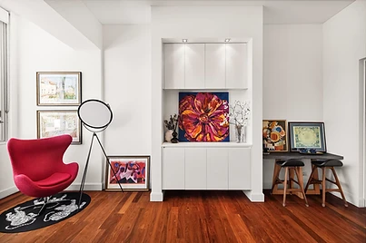 A magenta Egg chair framing the Sydney Harbour Bridge through the window