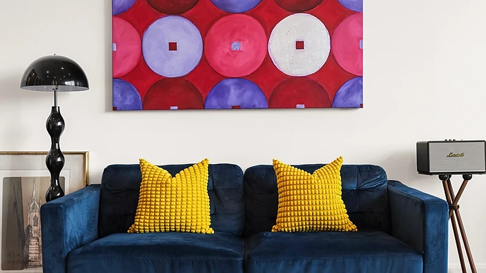 Styled interior with a deep blue sofa and Sydney Opera House view