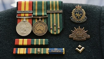 Realistic illustration of the military medals and badges awarded to Peter Badcoe, including Vietnam Medal, Australian Service Medal 1939-1945, shown against a light Australia flag background. AI-generated illustration, not an authentic photograph.