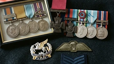 Realistic illustration of the military medals and badges awarded to Ian McKay, including Victoria Cross, shown against a light United Kingdom flag background. AI-generated illustration, not an authentic photograph.