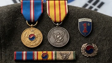 Realistic illustration of the military medals and badges awarded to Kim Han-su, including Order of Military Merit, Taegeuk, Order of Military Merit, Inheon, shown against a light South Korea flag background. AI-generated illustration, not an authentic photograph.