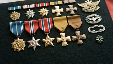 Realistic illustration of the military medals and badges awarded to Arturo Ortiz, including Medal of Valor, Distinguished Conduct Star, Distinguished Service Star, Gold Cross Medal, Bronze Cross Medal, shown against a light Philippines flag background. AI-generated illustration, not an authentic photograph.