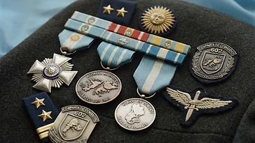 Realistic illustration of the military medals and badges awarded to Rubén Eduardo Márquez, shown against a light Argentina flag background. AI-generated illustration, not an authentic photograph.