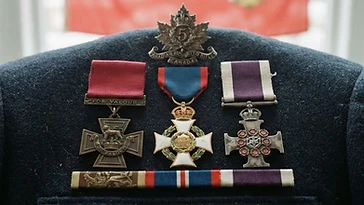Realistic illustration of the military medals and badges awarded to George Pearkes, including Victoria Cross, Distinguished Service Order, Military Cross, shown against a light Canada flag background. AI-generated illustration, not an authentic photograph.