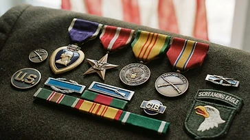 Realistic illustration of the military medals and badges awarded to Robert L. Worrell, shown against a light United States flag background. AI-generated illustration, not an authentic photograph.