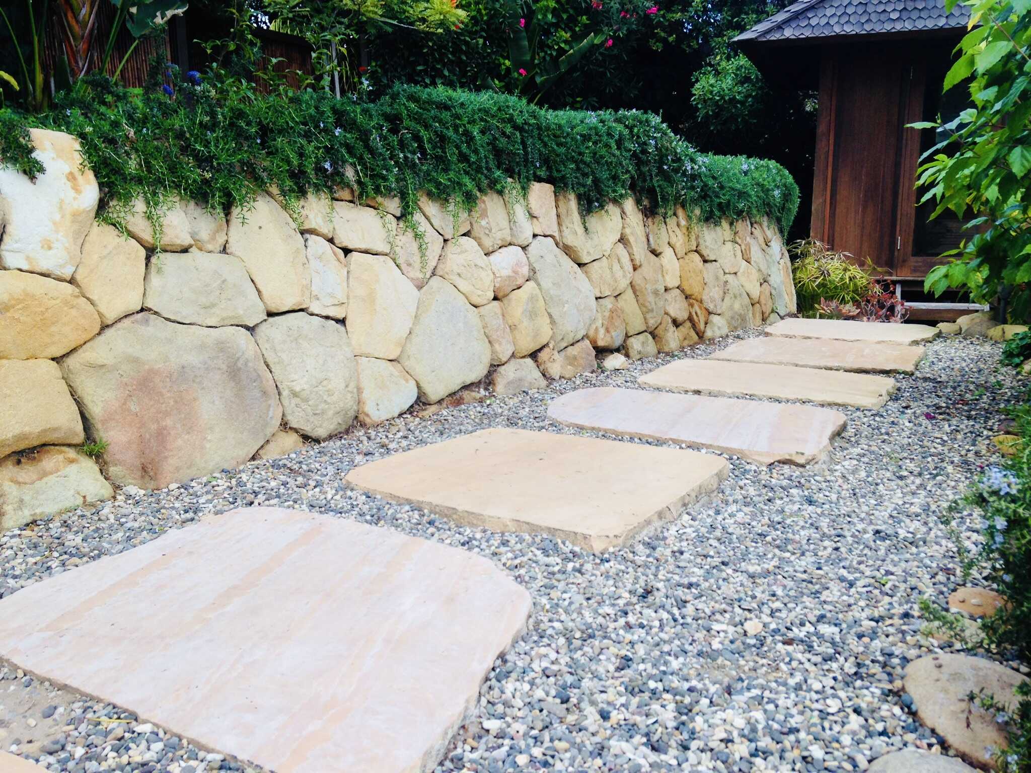 Sandstone retaining wall and flagstone stepping-stone path built by Reyes Gardening Services
