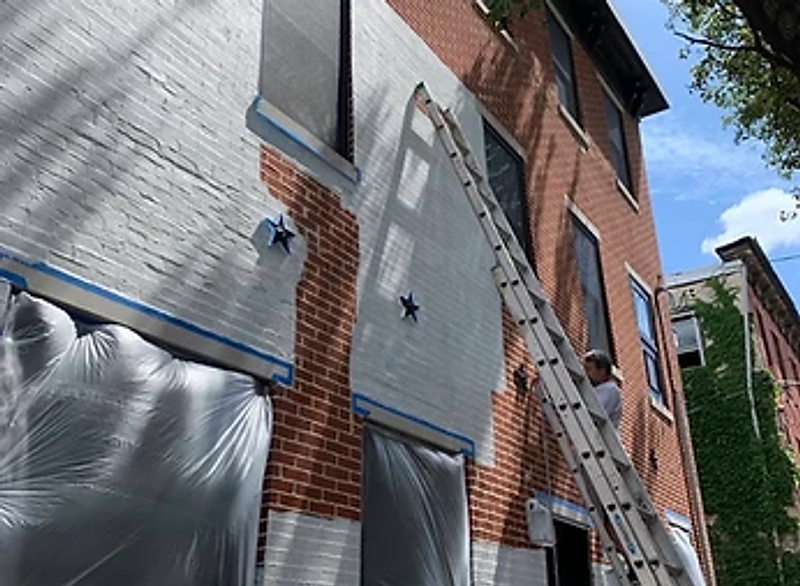 Ready Pro Painters crew repainting a brick building exterior