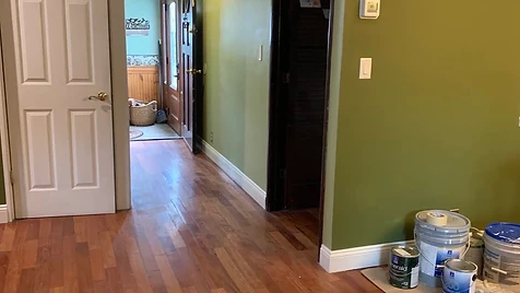 Sage Green Hallway — A hallway transformed in sage green with clean white trim — rolled by hand for even, streak-free coverage.