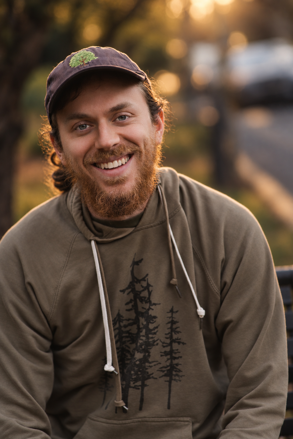 Portrait of a smiling bearded man in a dark jacket outdoors