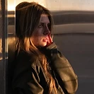 Woman in a leather jacket in warm golden-hour light
