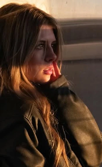 Woman in a leather jacket in warm golden-hour light