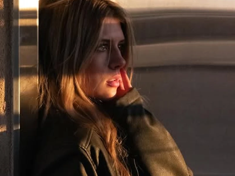 Woman in a leather jacket in warm golden-hour light