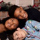 Three friends posed together for a holiday portrait