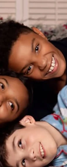 Three friends posed together for a holiday portrait