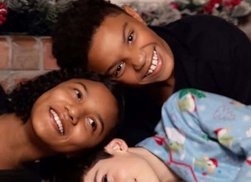 Three friends posed together for a holiday portrait
