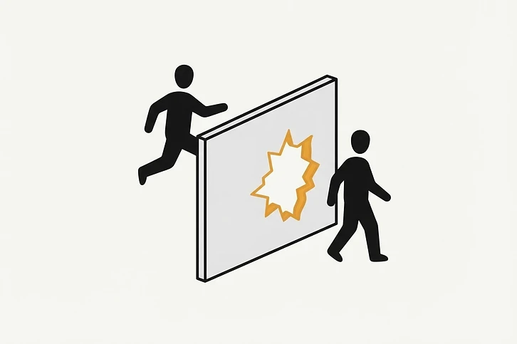 A person walks through a hole in a fragile paper wall meant to act as a barrier.