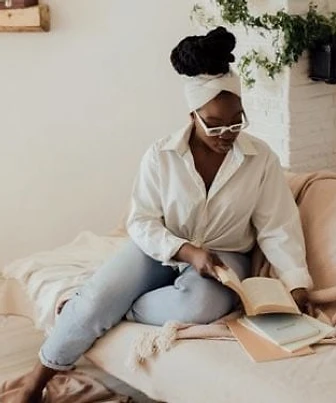 Join The Collective — A woman reading at rest, embodying the Richly Rested® philosophy