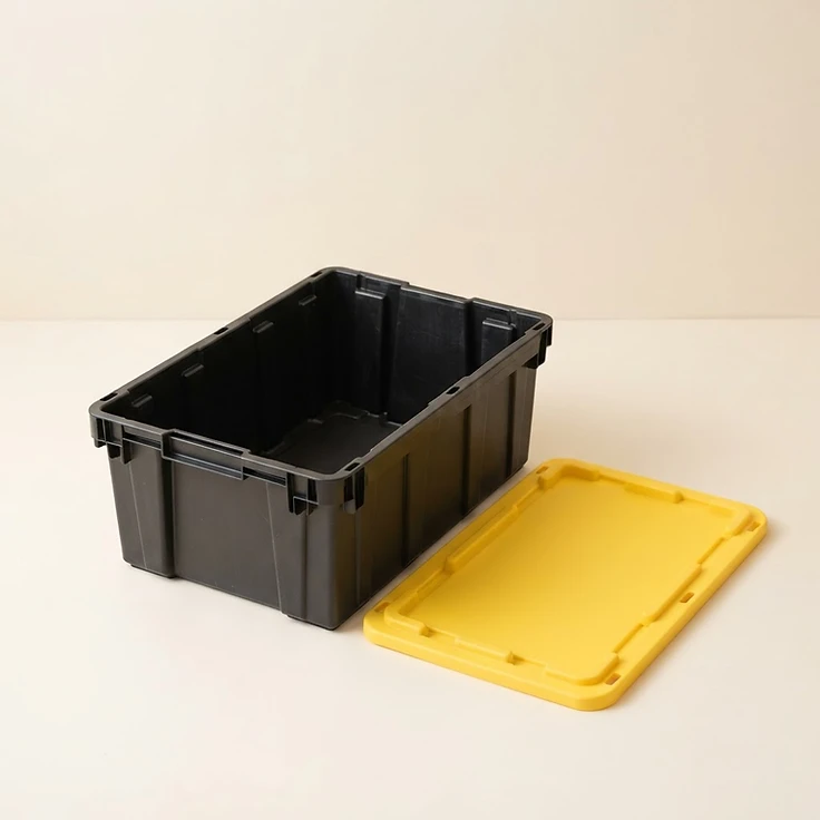 A black reusable moving box with its bright yellow lid removed, shown open