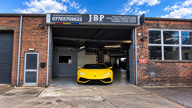 JBP Autos garage frontage with a yellow Lamborghini in the entrance
