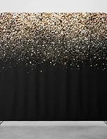 A gold glitter backdrop fading into deep matte black