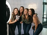 Wedding guests laughing with props at the Social Booth