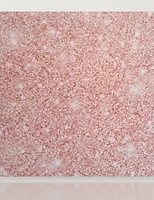 A rose gold sequin backdrop with a gentle sparkle