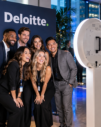 A corporate group posing in front of the photo booth and branded backdrop