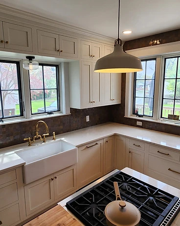 Kitchen backsplash in metallic mosaic tile with brass hardware