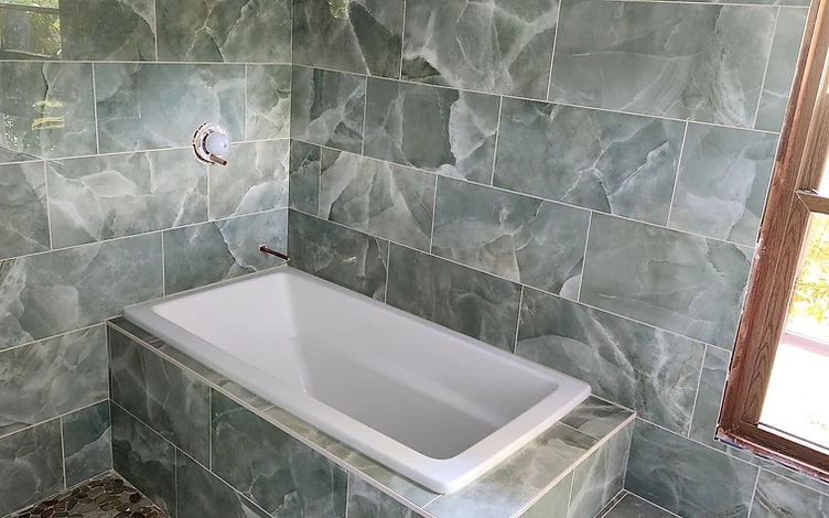 Green Marble Tub Deck — luxury bathroom tile installation by Lotto Custom Tile