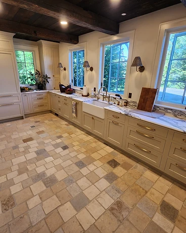Kitchen with a large-format backsplash panel and large-format tile floor